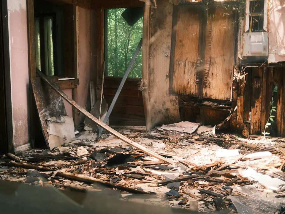 Charred walls and debris inside a damaged room
